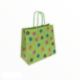 Buste shopper in carta fantasia verde con maniglie a cordino